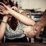 Woman Covering Her Face In Fear Of Domestic Violence