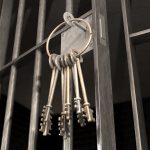 Jail Cell With Open Door And Bunch Of Keys